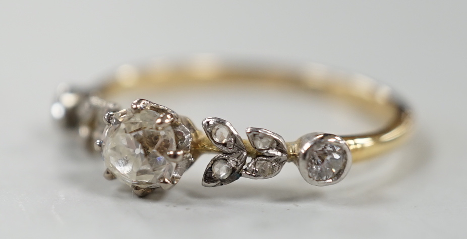 An 18ct and diamond cluster set half hoop ring, of foliate design, size N, gross weight 2.3 grams.